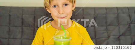 The boy is drinking Green tea latte with ice in mason jar. Homemade Iced Matcha Latte Tea with Milk zero waste BANNER, LONG FORMAT The boy is drinking Green tea latte with ice in mason jar. Homemade Iced Matcha Latte Tea with Milk zero waste BANNER, LONG FORMAT 120316169