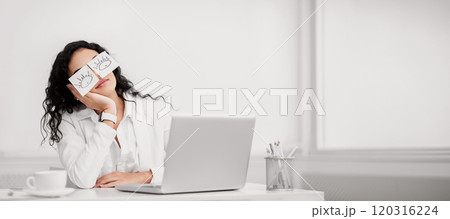 Insomnia. Lazy unproductive office worker girl wearing funny sticky notes on her eyes sleeping at workplace, copyspace 120316224
