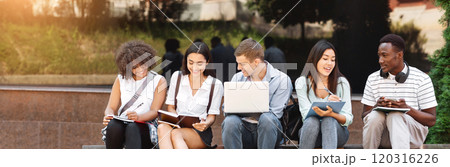 Group of happy teen high school students studying outdoors, preparing for lectures together, free space 120316226