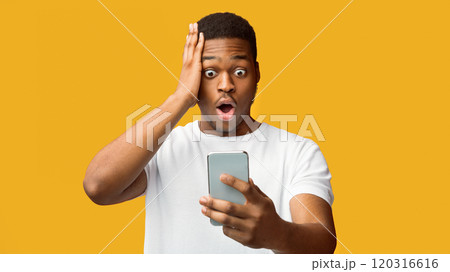 Bad News. Portrait of shocked scared black man looking at phone seeing terrible message, nervous reaction Bad News. Portrait of shocked scared black man looking at phone seeing terrible message, nervous reaction 120316616