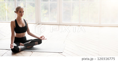 Relaxed yoga girl sitting in lotus pose and meditating at home, no stress concept, copy space 120316775