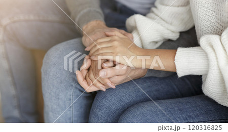 Happy Reconciliation. Unrecognizable Couple Holding Hands Sitting On Couch During Family Therapy Session Indoor. Cropped, Selective Focus Happy Reconciliation. Unrecognizable Couple Holding Hands Sitting On Couch During Family Therapy Session Indoor. Cropped, Selective Focus 120316825