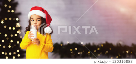 Christmas Eve drink for kids. Cute little african american girl enjoying warm milk at home, empty space 120316888