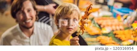Dad and son are tourists on Walking street Asian food market BANNER, LONG FORMAT Dad and son are tourists on Walking street Asian food market BANNER, LONG FORMAT 120316954