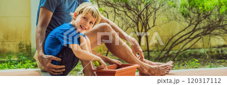 Father and son gardening in the garden near the house BANNER, LONG FORMAT 120317112