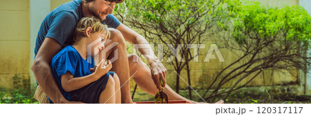 Father and son gardening in the garden near the house BANNER, LONG FORMAT Father and son gardening in the garden near the house BANNER, LONG FORMAT 120317117