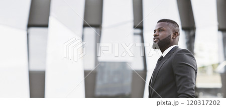 Young Black Businessman Looking Aside Standing In Urban Area. Starting Business Career. Free Space For Text Young Black Businessman Looking Aside Standing In Urban Area. Starting Business Career. Free Space For Text 120317202