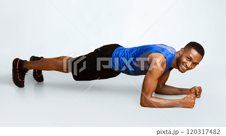 Sportive Black Man Doing Plank Core Exercise Training Back And Press Muscles, Full Length Panorama, Yellow Studio Wall Sportive Black Man Doing Plank Core Exercise Training Back And Press Muscles, Full Length Panorama, Yellow Studio Wall 120317482