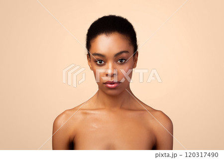 Portrait Of Serious African Young Woman Posing Shirtless Looking At Camera Standing Over Gray Studio Background. Female Headshot Of Black Lady. Sensuality And Natural Beauty Concept 120317490