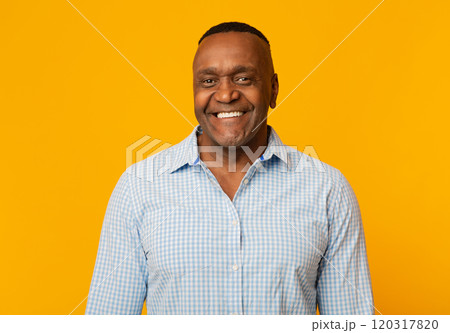 Portrait of middle aged african american man with happy smile, orange background 120317820
