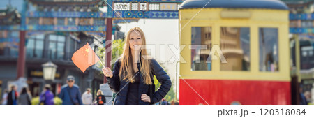 Enjoying vacation in China. Young woman with national chinese flag on the background of the old Chinese street. Travel to China concept. Visa free transit 72 hours, 144 hours in China BANNER, LONG Enjoying vacation in China. Young woman with national chinese flag on the background of the old Chinese street. Travel to China concept. Visa free transit 72 hours, 144 hours in China BANNER, LONG 120318084