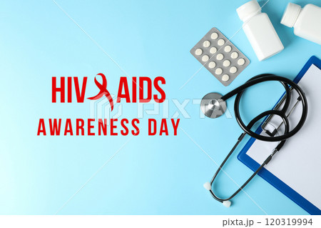 AIDS day, medicines and medical equipment on a blue background with text top view AIDS day, medicines and medical equipment on a blue background with text top view 120319994