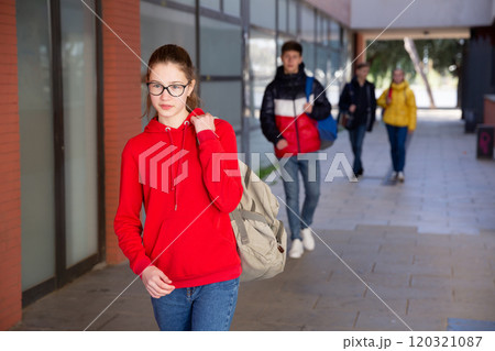Teen girl in glasses walking to college 120321087
