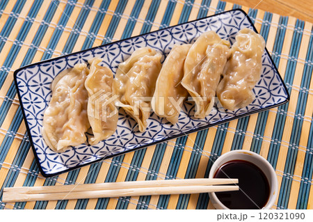 Japanese gyoza dumplings served on platter 120321090