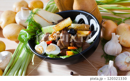 Healthy salad with chicken hearts served in pan 120321330