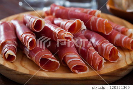 Rolled up slices of dry-cured ham 120321369