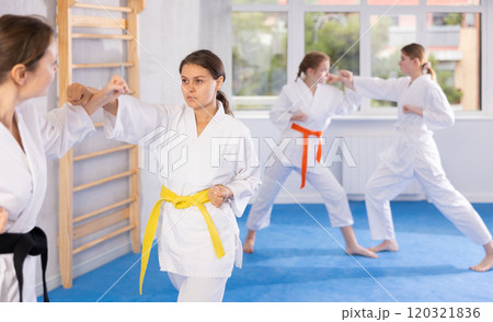 Females in kimono practicing fighting moves Females in kimono practicing fighting moves 120321836