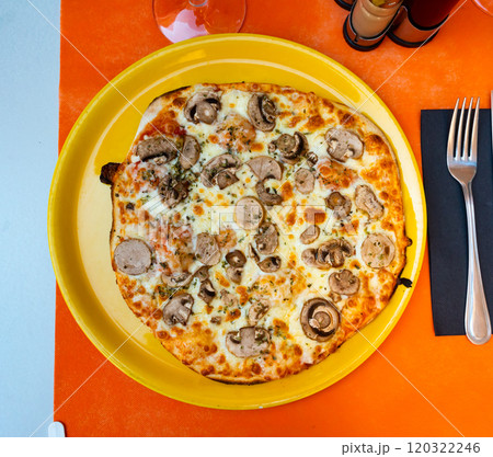 in fast food restaurant freshly baked thin-crust pizza with mushrooms on yellow plate in fast food restaurant freshly baked thin-crust pizza with mushrooms on yellow plate 120322246
