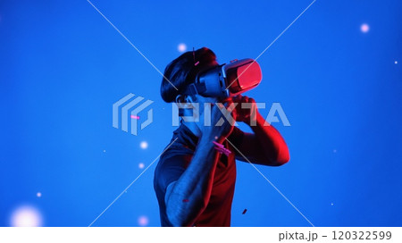 Gamer boxing and punching floating box while wearing VR glasses. Apparatus. Gamer boxing and punching floating box while wearing VR glasses. Apparatus. 120322599