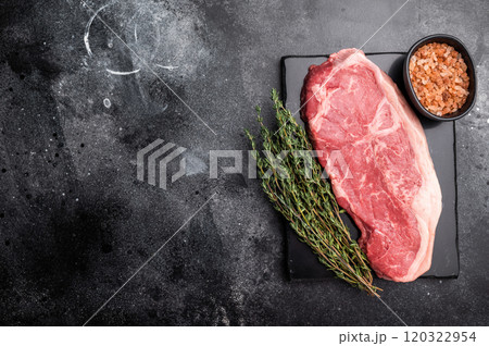 Raw striploin beef steak, New York strip steak. black background. top view Raw striploin beef steak, New York strip steak. black background. top view 120322954