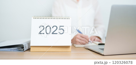 2025 Year Calendar on table with business woman using laptop computer, working and writing in office. countdown, Happy New Year, Resolution, Year End and New Start and Goals Plan Action Concept 2025 Year Calendar on table with business woman using laptop computer, working and writing in office. countdown, Happy New Year, Resolution, Year End and New Start and Goals Plan Action Concept 120326078