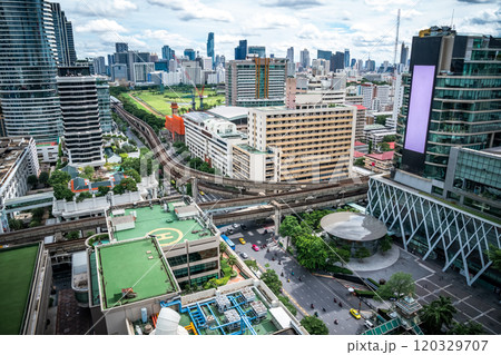 Bangkok Aerial Skyline and Skytrain view of Thailand. Business and financial building area centers with smart green park among urban city at noon time. Bangkok Aerial Skyline and Skytrain view of Thailand. Business and financial building area centers with smart green park among urban city at noon time. 120329707