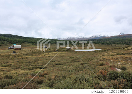 Lake and snow-capped mountains in cloudy weather Lake and snow-capped mountains in cloudy weather 120329963