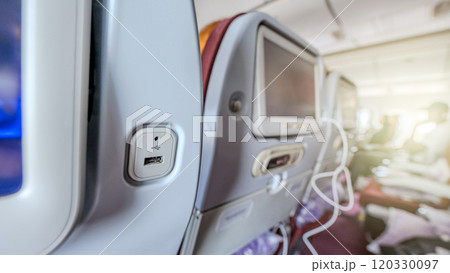 Convenience meets travel with USB ports at airplane seats, providing a practical solution for charging electronic devices on the go. Convenience meets travel with USB ports at airplane seats, providing a practical solution for charging electronic devices on the go. 120330097