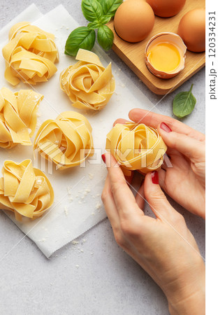 Chef preparing homemade tagliatelle pasta with eggs and basil 120334231