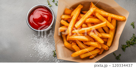 French fries. Pommes frites. Chips. French fries in a paper wrap with ketchup dip 120334437