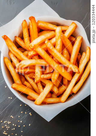 French fries. Pommes frites. Chips. French fries in a paper wrap with ketchup dip French fries. Pommes frites. Chips. French fries in a paper wrap with ketchup dip 120334444