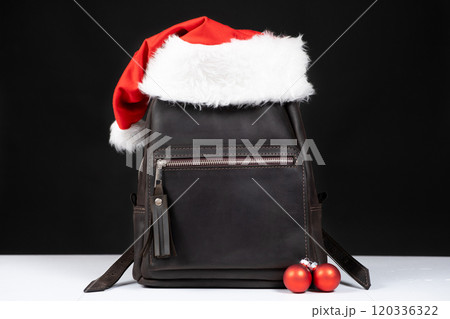 Leather Backpack With Santa Hat. Christmas for leather goods and handbags stores Leather Backpack With Santa Hat. Christmas for leather goods and handbags stores 120336322