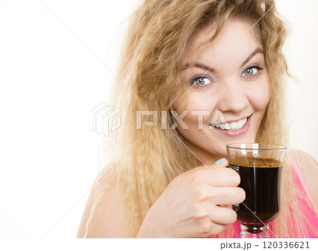 Positive woman drinking her morning coffee Positive woman drinking her morning coffee 120336621