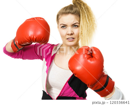 Woman wearing boxing gloves 120336641
