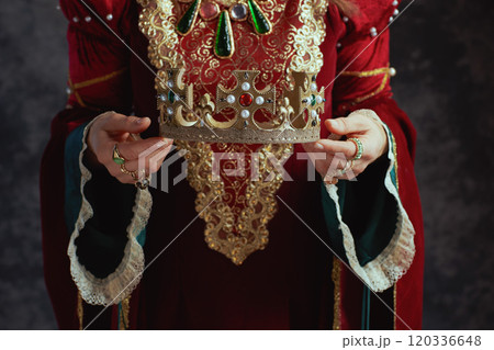Closeup on medieval queen in red dress with crown Closeup on medieval queen in red dress with crown 120336648