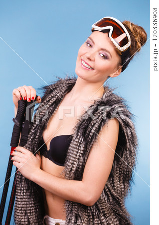 Sexy woman holding ski poles 120336908
