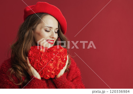 relaxed trendy female in red sweater and beret with red heart relaxed trendy female in red sweater and beret with red heart 120336984