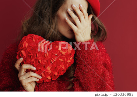 Closeup on female in red sweater and beret with red heart Closeup on female in red sweater and beret with red heart 120336985