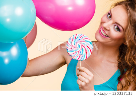 Woman with colorful balloons and lollipop Woman with colorful balloons and lollipop 120337133