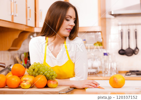 Smiling lady in kitchen. 120337152