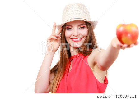 Woman summer hat colorful makeup holds apple fruit 120337311