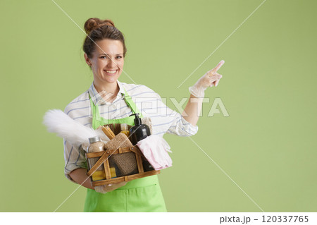smiling modern woman pointing on copy space isolated on green smiling modern woman pointing on copy space isolated on green 120337765