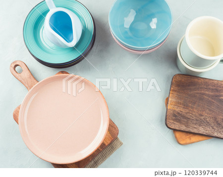 Set of pastel pink, blue color tableware on turquoise background Set of pastel pink, blue color tableware on turquoise background 120339744