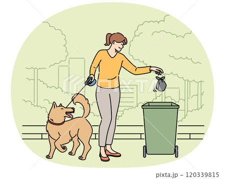 Woman walking dog throws bag of puppy poop into trash can, taking care of cleanliness of park 120339815