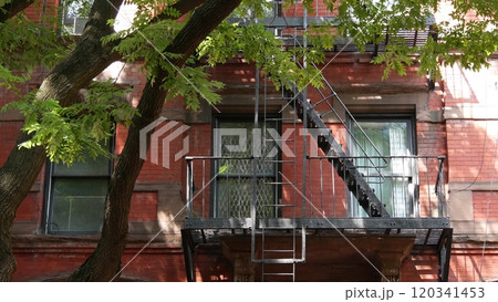 New York City building architecture, Manhattan. Residential house exterior. Red brick, fire escape. New York City building architecture, Manhattan. Residential house exterior. Red brick, fire escape. 120341453