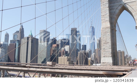 Brooklyn Bridge cables, Manhattan downtown. New York City skyline, financial district cityscape. Brooklyn Bridge cables, Manhattan downtown. New York City skyline, financial district cityscape. 120341639