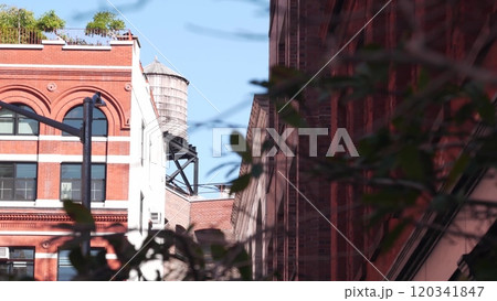 New York City Manhattan architecture, USA. Residential house exterior. Red brick facade, water tower 120341847