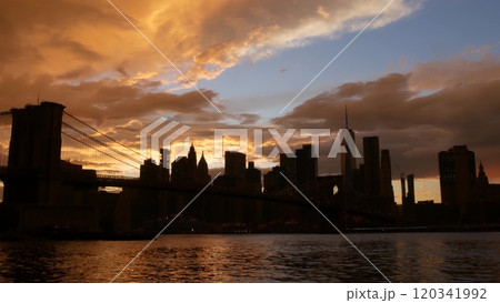 Brooklyn Bridge, Dumbo. New York City Manhattan downtown skyline. Dramatic sunset cloudy sky, USA. Brooklyn Bridge, Dumbo. New York City Manhattan downtown skyline. Dramatic sunset cloudy sky, USA. 120341992