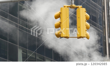 Steam vapor vented, New York City street steam system, orange vapour tube stack. Hot smoke from pipe 120342085