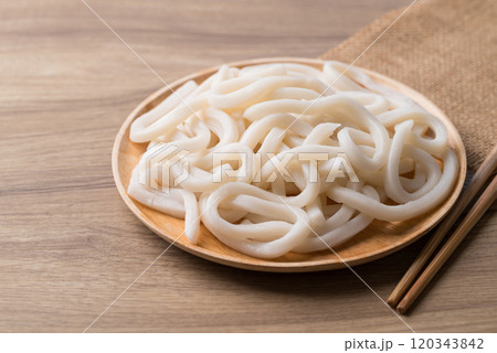 Udon noodles on wooden plate with chopsticks, Thick noodles in Japanese cuisine 120343842